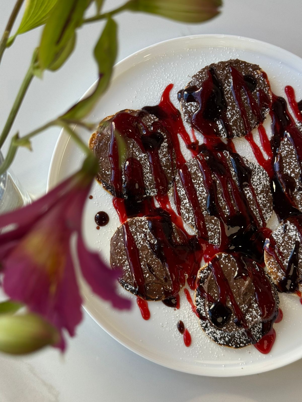 Chocolate pancakes with berry sauce